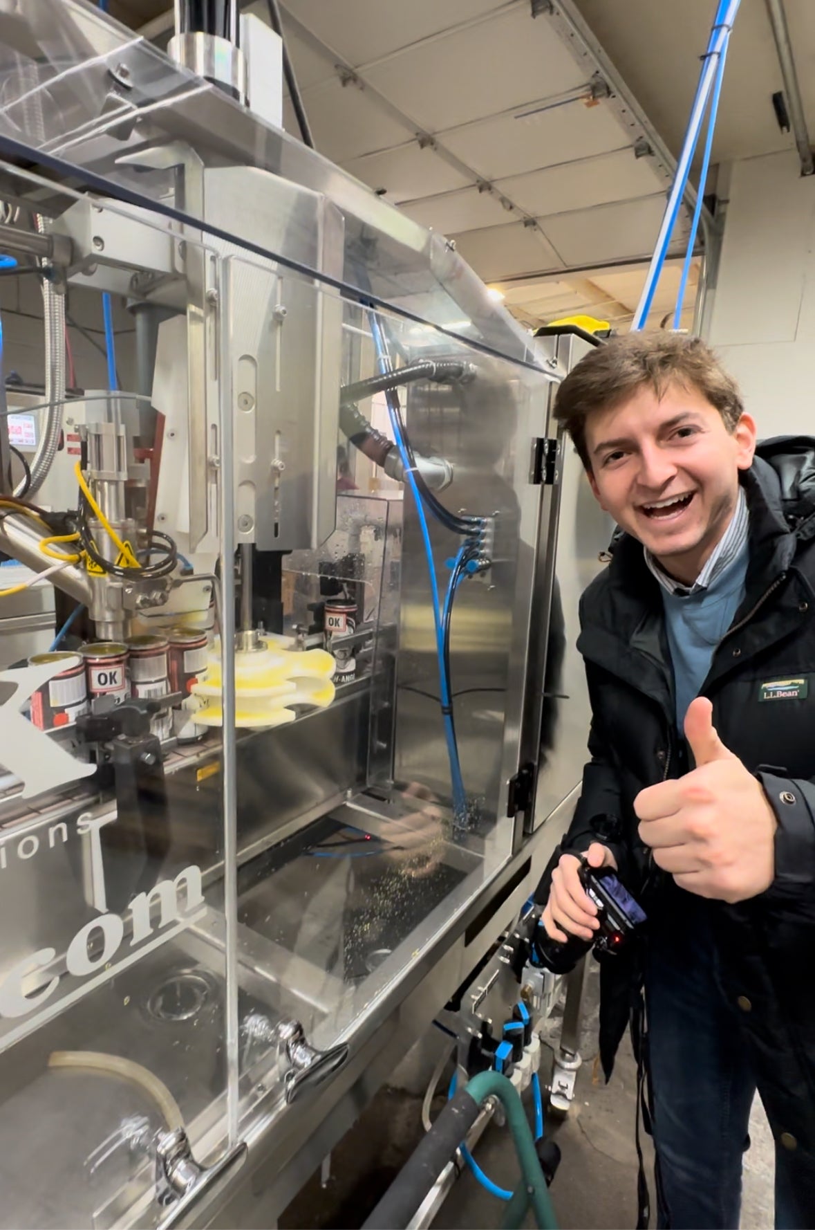 Evan, founder of OK Energy, inspects bottling at a production facility.